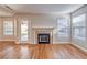 Light-filled living room with a fireplace and multiple windows at 1933 Coralino Dr, Henderson, NV 89074