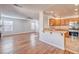 Open concept living room with wood floors flowing into a well-lit kitchen at 1933 Coralino Dr, Henderson, NV 89074