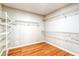 Walk-in closet with wire shelving, providing ample storage space, and hardwood flooring at 1933 Coralino Dr, Henderson, NV 89074