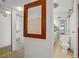 Hallway view into a well-lit bathroom with a large mirror and multiple vanities at 205 E Harmon Ave # 306, Las Vegas, NV 89169