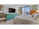 Inviting bedroom boasts natural light, city views, and light teal dresser at 205 E Harmon Ave # 306, Las Vegas, NV 89169