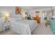 Bedroom featuring a bed, dresser, nightstand, art, and chair with city views outside at 205 E Harmon Ave # 306, Las Vegas, NV 89169