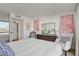 Bright bedroom with a bed, paintings, chairs, and city views through a sliding glass door at 205 E Harmon Ave # 306, Las Vegas, NV 89169