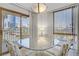 Dining area with glass table highlights city views from the sliding glass door and natural light at 205 E Harmon Ave # 306, Las Vegas, NV 89169