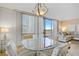 Dining area showcases a glass table open to the living room with natural light from the sliding glass door at 205 E Harmon Ave # 306, Las Vegas, NV 89169