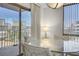 Dining area with glass table showcases city views from the sliding glass door at 205 E Harmon Ave # 306, Las Vegas, NV 89169