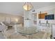 View of dining area with glass table open to the living room, offering a seamless flow for entertaining at 205 E Harmon Ave # 306, Las Vegas, NV 89169