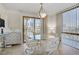 Dining area features a glass table, sliding glass door and city views at 205 E Harmon Ave # 306, Las Vegas, NV 89169