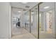Hallway featuring mirrored closets, leading to a bathroom and bedroom at 205 E Harmon Ave # 306, Las Vegas, NV 89169