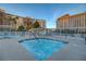 Inviting hot tub with railing offers a relaxing outdoor space among building exteriors at 205 E Harmon Ave # 306, Las Vegas, NV 89169