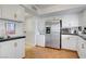 Updated kitchen with stainless steel appliances, in-unit washer/dryer, and tile floors at 205 E Harmon Ave # 306, Las Vegas, NV 89169