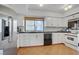 The kitchen features white cabinets, tiled floors, stainless steel appliances and a window at 205 E Harmon Ave # 306, Las Vegas, NV 89169