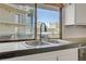 The kitchen sink has a beautiful view of the city skyline through the window at 205 E Harmon Ave # 306, Las Vegas, NV 89169