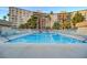Large swimming pool surrounded by lounge chairs and lush landscaping, perfect for relaxation at 205 E Harmon Ave # 306, Las Vegas, NV 89169