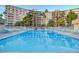 Large swimming pool surrounded by lounge chairs and lush landscaping, perfect for relaxation at 205 E Harmon Ave # 306, Las Vegas, NV 89169