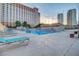 Large swimming pool with lounge chairs offers a relaxing outdoor space for residents at 205 E Harmon Ave # 306, Las Vegas, NV 89169