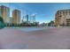 Community tennis courts with a backdrop of the city skyline at 205 E Harmon Ave # 306, Las Vegas, NV 89169