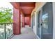 Balcony with glass railing overlooking the landscape and mature trees at 23 E Agate Ave # 207, Las Vegas, NV 89123