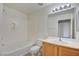 Bathroom featuring a single sink vanity with shower over tub and toilet at 23 E Agate Ave # 207, Las Vegas, NV 89123