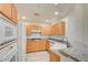 Bright kitchen with stainless steel appliances, stone countertops, wood cabinets, and plenty of storage space at 23 E Agate Ave # 207, Las Vegas, NV 89123