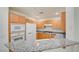 Charming kitchen featuring granite countertops, wooden cabinets, modern appliances, and breakfast bar at 23 E Agate Ave # 207, Las Vegas, NV 89123