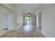 Bright living room featuring wood flooring, ceiling fan, access door to hallway, and sliding door to patio at 23 E Agate Ave # 207, Las Vegas, NV 89123