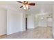 Open concept living room with ceiling fan, light walls, and wood flooring at 23 E Agate Ave # 207, Las Vegas, NV 89123