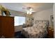 Cozy bedroom with a floral patterned bedspread, vanity, and a ceiling fan for added comfort at 2305 Flower Spring St, Las Vegas, NV 89134