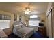 Bedroom showcasing a bed with blue and white striped bedding and coordinating window treatments at 2305 Flower Spring St, Las Vegas, NV 89134