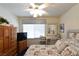 Charming bedroom featuring a floral bed, a large window for natural light, and wooden furniture at 2305 Flower Spring St, Las Vegas, NV 89134