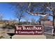 Trails Park & Community Pool sign is surrounded by desert landscaping and mature trees at 2305 Flower Spring St, Las Vegas, NV 89134