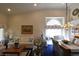 Comfortable living room and dining area featuring vaulted ceilings, stylish furnishings, and a cozy window seat at 2305 Flower Spring St, Las Vegas, NV 89134