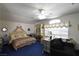 A serene main bedroom has a canopy bed, a sitting area, and elegant furnishings at 2305 Flower Spring St, Las Vegas, NV 89134