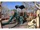 Playground structure with slide, climbing area, and platforms under a green awning at 2305 Flower Spring St, Las Vegas, NV 89134