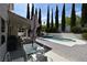 Outdoor patio area featuring a pool and covered seating with a grill at 2305 Flower Spring St, Las Vegas, NV 89134