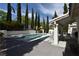 Backyard pool with surrounding patio and covered outdoor seating area at 2305 Flower Spring St, Las Vegas, NV 89134