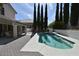 Backyard swimming pool with surrounding brick patio and covered area at 2305 Flower Spring St, Las Vegas, NV 89134
