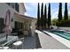 Backyard features a pool, spa, patio, and covered seating with grill at 2305 Flower Spring St, Las Vegas, NV 89134