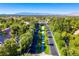 Aerial view of community lined with mature trees and landscaping, showcasing distant mountain views at 2316 Prometheus Ct, Henderson, NV 89074