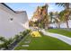 A beautifully landscaped backyard with a sparkling pool and lush artificial grass at 2316 Prometheus Ct, Henderson, NV 89074