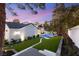 Beautiful backyard with pool, green lawn, and lovely landscaping creates a serene outdoor retreat at 2316 Prometheus Ct, Henderson, NV 89074