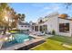 Lush backyard with a sparkling pool and comfortable lounge chairs, ideal for entertaining at 2316 Prometheus Ct, Henderson, NV 89074