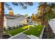 Expansive backyard highlighting a pool, landscaped areas, and lush green artificial turf at 2316 Prometheus Ct, Henderson, NV 89074