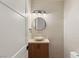 Stylish powder room featuring a vessel sink and modern lighting at 2316 Prometheus Ct, Henderson, NV 89074