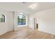 Bright bedroom featuring wood floors, a large arch window and ensuite access at 2316 Prometheus Ct, Henderson, NV 89074