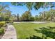 This community park provides a grassy area with mature landscaping, walking paths, and recreational sport courts at 2316 Prometheus Ct, Henderson, NV 89074