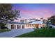 Stunning two-story home with lush landscaping, a three-car garage, and a circular driveway at 2316 Prometheus Ct, Henderson, NV 89074