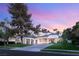 Elegant home featuring a lush front lawn, large shade trees and attached three car garage at 2316 Prometheus Ct, Henderson, NV 89074