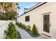 Beautiful home exterior featuring a charming walkway with lush landscaping and a modern white door at 2316 Prometheus Ct, Henderson, NV 89074