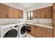 Well-lit laundry room featuring front-load washer and dryer and custom cabinets at 2316 Prometheus Ct, Henderson, NV 89074